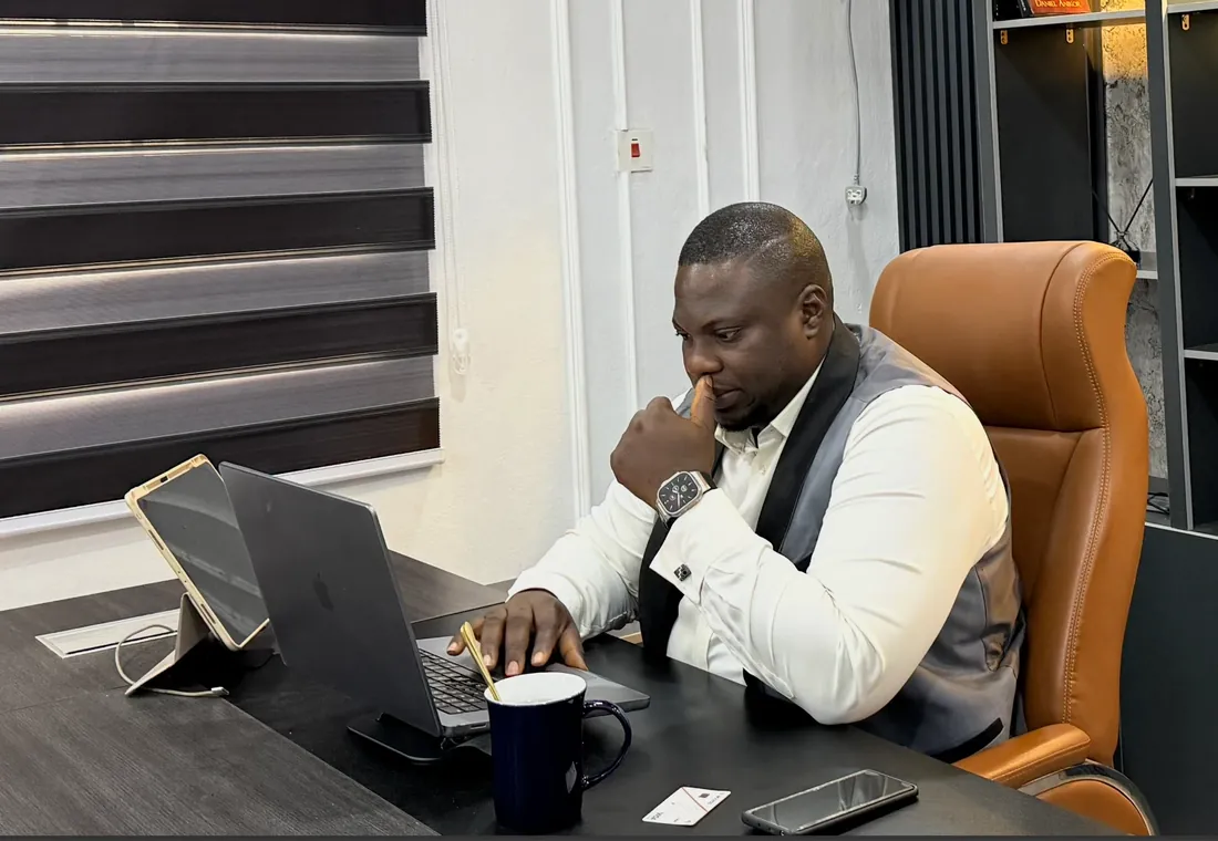 Fredrick Eghosa, AI SEO expert in Lagos, Nigeria, reviewing a client's search data on his laptop